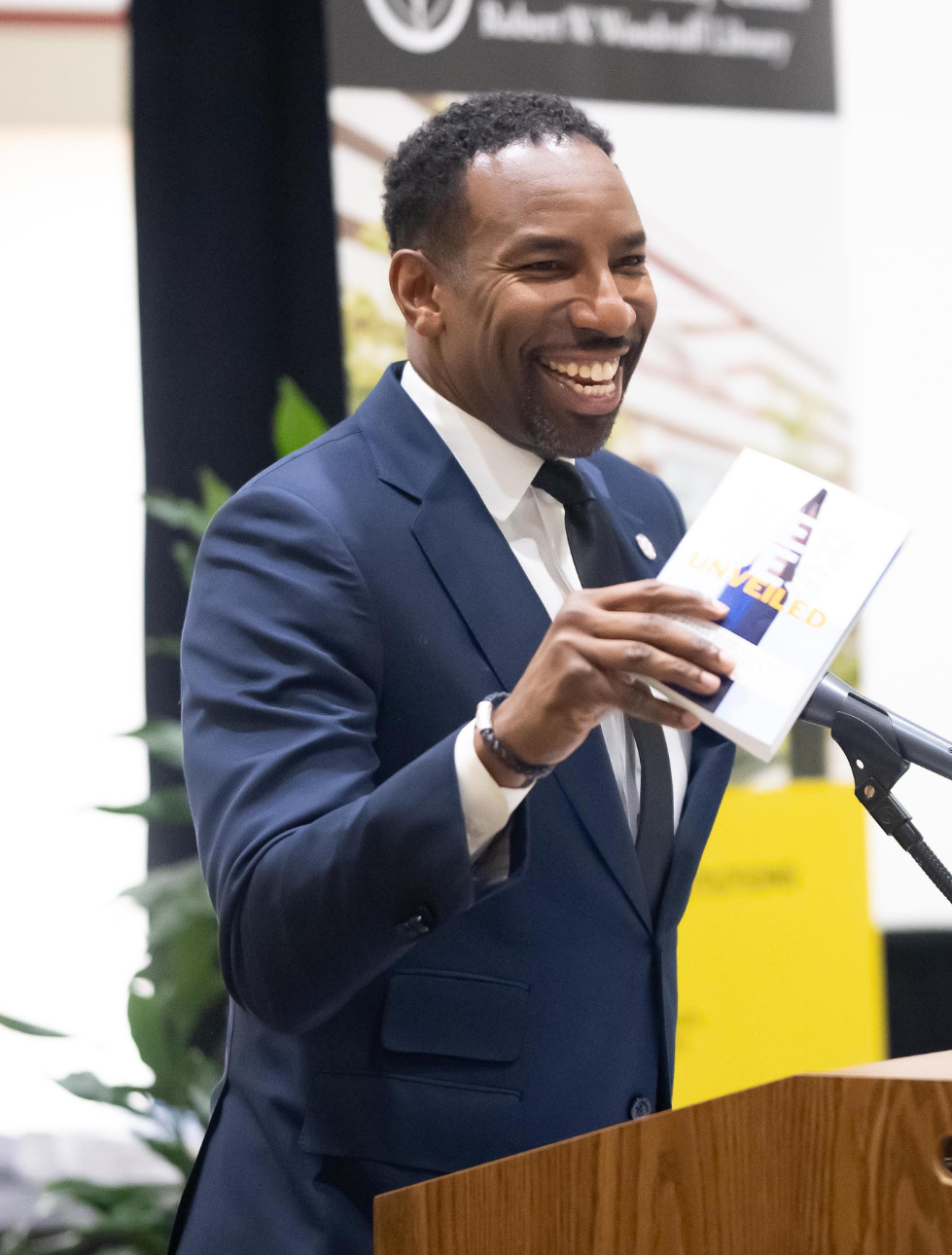 Atlanta Mayor Andre Dickens holding a Beyond Literacy student-authored book